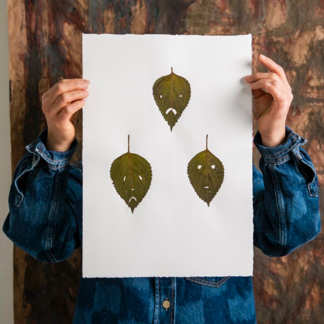 Ginger Brooks Takahashi holding artwork.